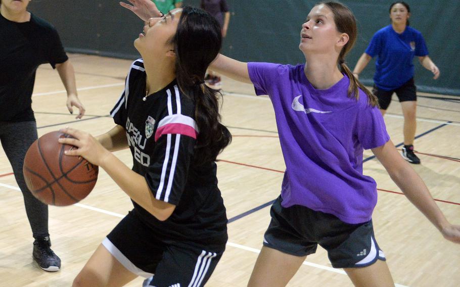 Daegu's girls basketball team features a mix of veterans, such as senior Emma Sims, right, and freshman Gianna Tak.