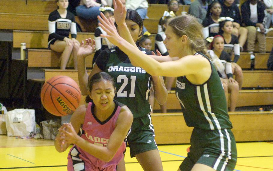 Kadena's Jazlene Vergara loses the handle on the ball while guarded by Kubasaki's Solares Solano and Lillian Law during Friday's Okinawa girls basketball game. The Dragons won 28-24, giving them a 3-1 season-series edge over the Panthers, their first in 20 seasons.