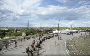 In this photo taken from video released by the Russian Defense Ministry on Saturday, May 21, 2022, Ukrainian servicemen line up to be checked as they leave the besieged Azovstal steel plant in Mariupol, in territory under the government of the Donetsk People's Republic, eastern Ukraine. (Russian Defense Ministry Press Service via AP)