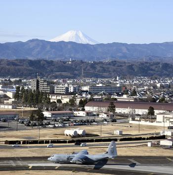 With Mount Fuji in the background, a C-130J Super Hercules prepares to take off at Yokota Air Base, Japan, Tuesday, Jan. 31, 2023. 