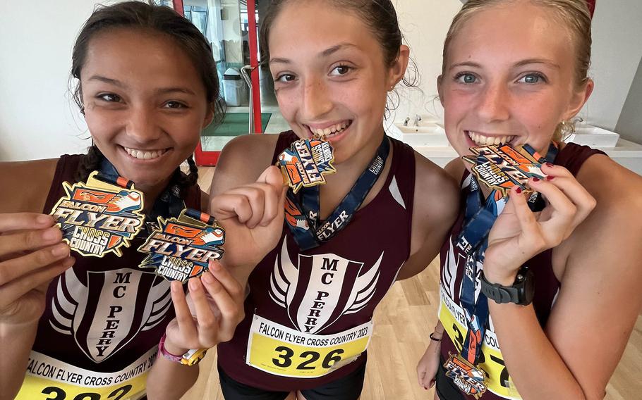 Matthew C. Perry's Isabella Cordes, McKenzie Steele and Jane Williams display their hardware following Saturday's Canadian Academy Falcon Flyer cross country race in Kobe. Williams took first place, Cordes second and Steele fifth.