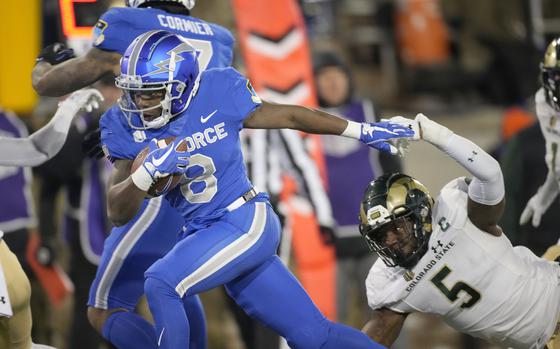 Air Force wide receiver DeAndre Hughes drives past Colorado State linebacker Dequan Jackson in the first half of an NCAA college football game Saturday, Nov. 19, 2022, at Air Force Academy, Colo.