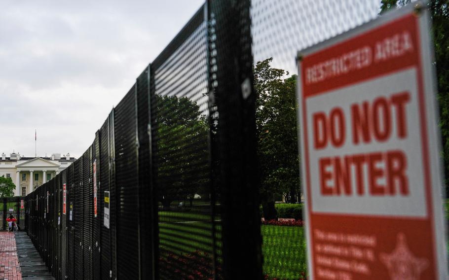 A close-up of a fence with a “Do not enter” sign on it.