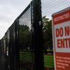 A close-up of a fence with a “Do not enter” sign on it.