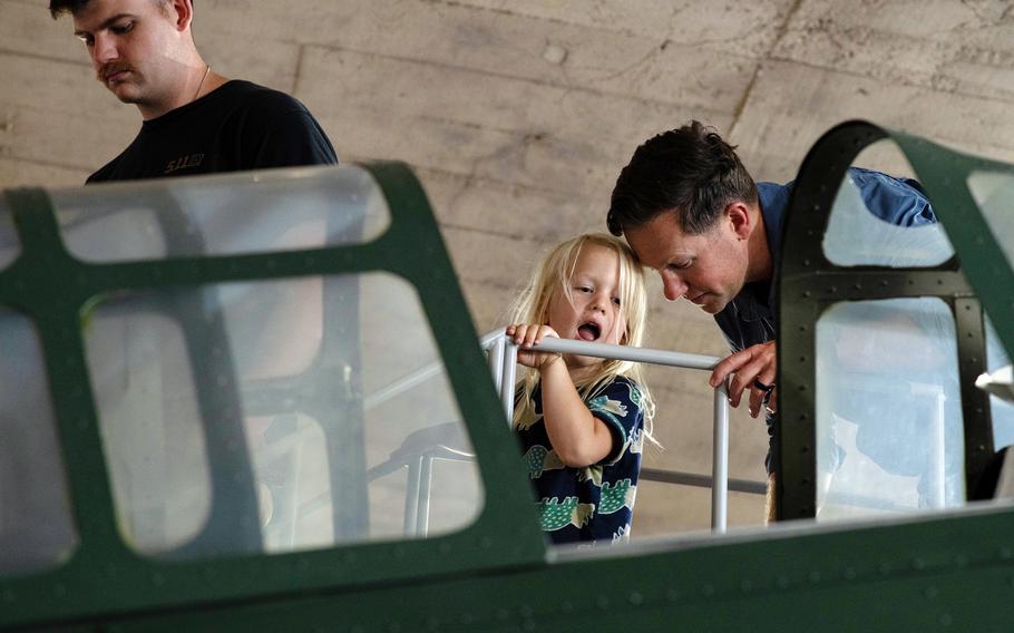 A young guest checks out the replica Zero fighter on display.