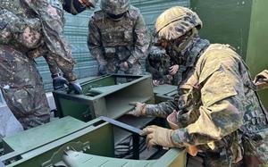South Korean soldiers inspect loudspeaker equipment at an unspecified location near the Demilitarized Zone, June 9, 2024.