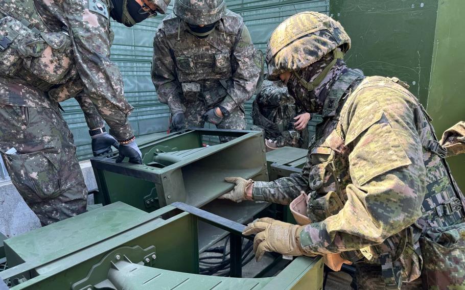 South Korean soldiers inspect loudspeaker equipment.