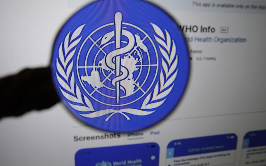 The logo for the World Health Organization Info application is displayed on a computer screen Bern, Switzerland, on March 31, 2020.