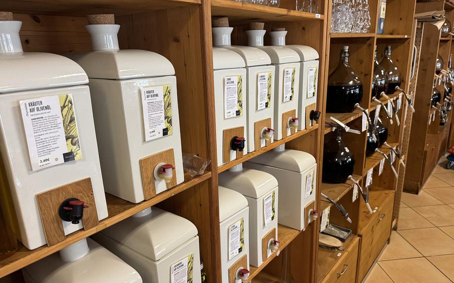 Jugs of olive oil on wooden shelves