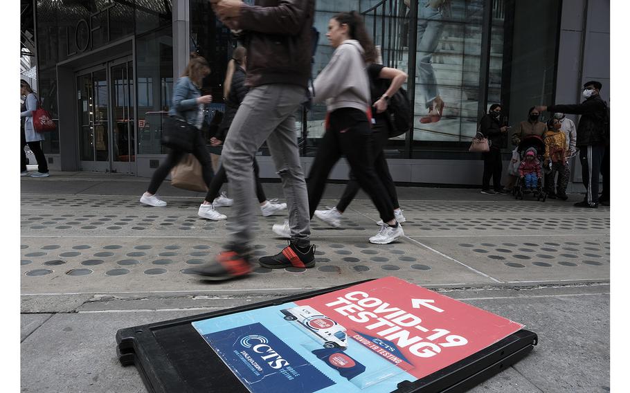 A sign alerts people to a COVID-19 testing site in Times Square on May 3, 2022, in New York City. 