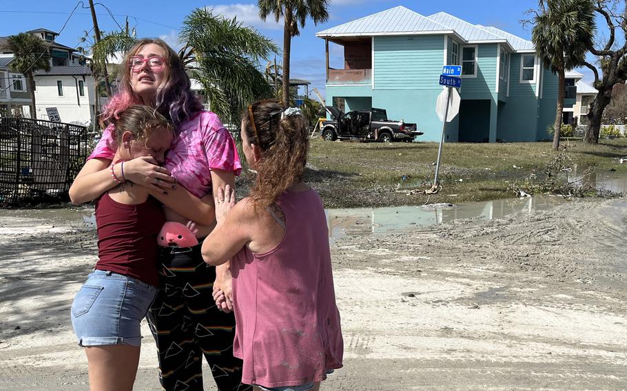 Kristelle Reed comforts Courtney Schneider after they discovered what they lost in Fort Myers Beach, Fla., on Thursday, Sept. 29, 2022. Reed said her apartment in Fort Myers Beach had flooded, killing her pet fish. Schneider watched her car float away in the storm surge. 