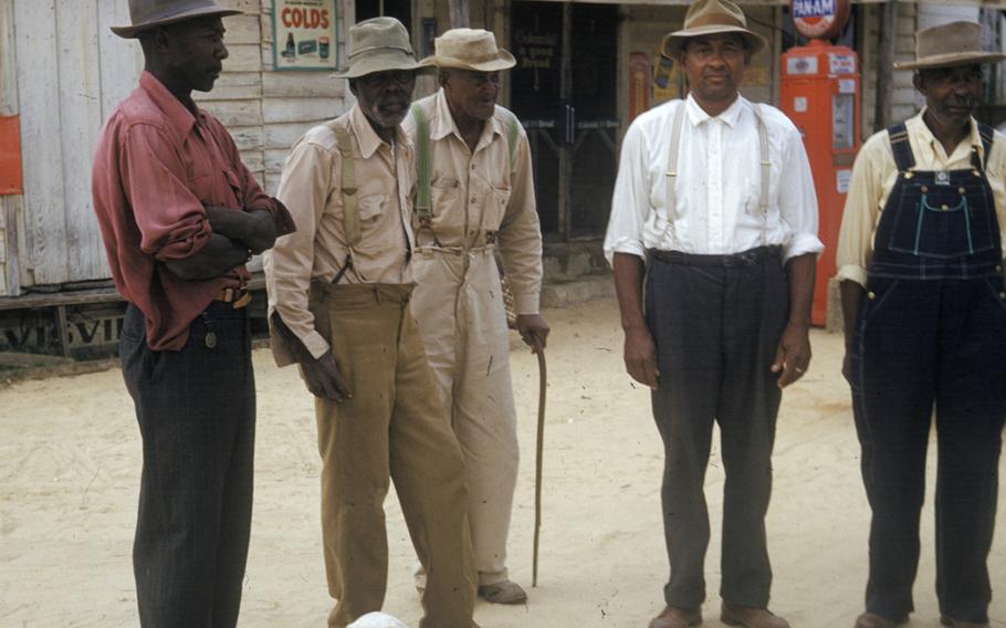 In this 1950s photo, men included in a syphilis study pose for a photo in Tuskegee, Ala. 