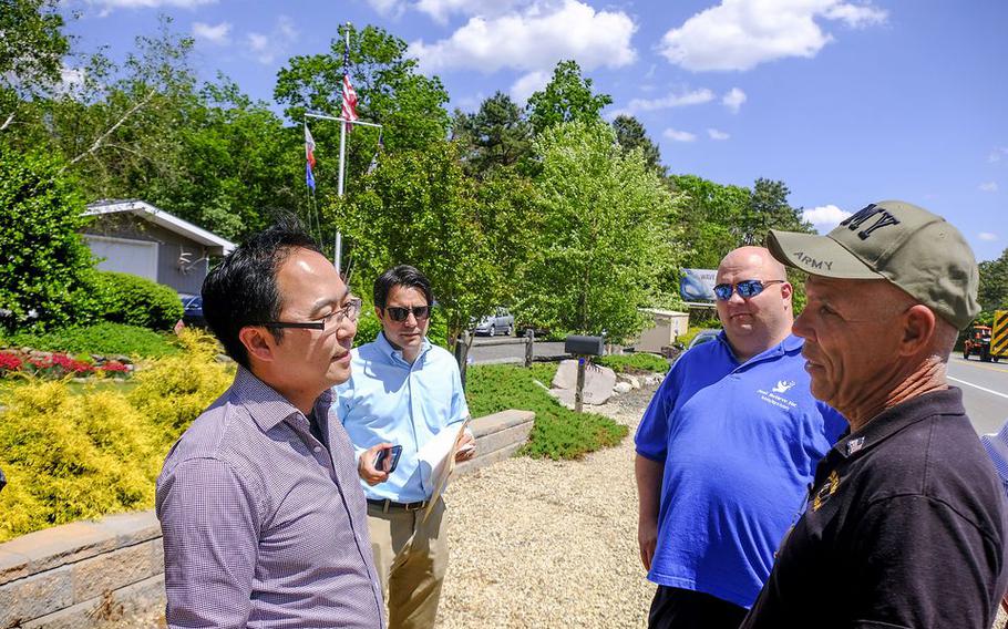 Marty Weber, right, the owner of the land talks to Rep. Andy Kim, left, as Just Believe director Paul Hulse, 2nd from right, listens as they stand by some of 36 acres being donated. 