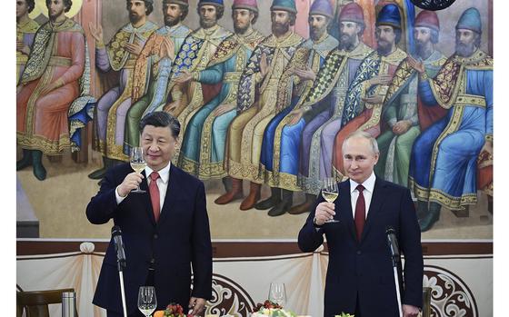 Russian President Vladimir Putin, right, and China's President Xi Jinping hold toast during a reception following their talks at the Kremlin in Moscow on March 21, 2023. (Pavel Byrkin/SPUTNIK/AFP/Getty Images/TNS)