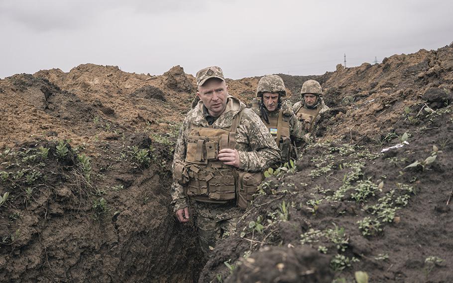 Brigadier General Mykhaylo Drapatyy walks through a trench in Kherson region in April 2023. 