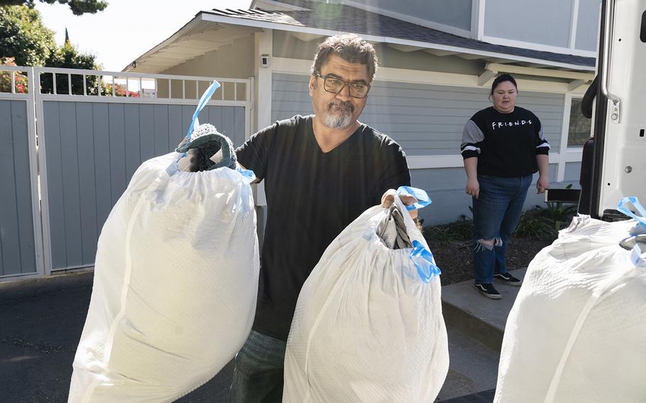 Sedat Deniz loads donations into his company’s truck in Los Angeles on Feb. 9, 2023.