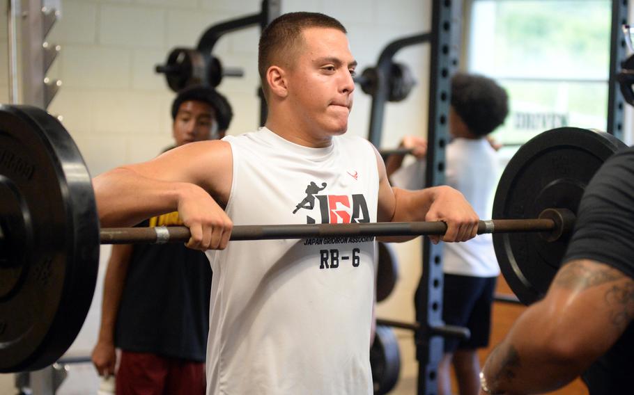 Ethan Ferch lifts weights.