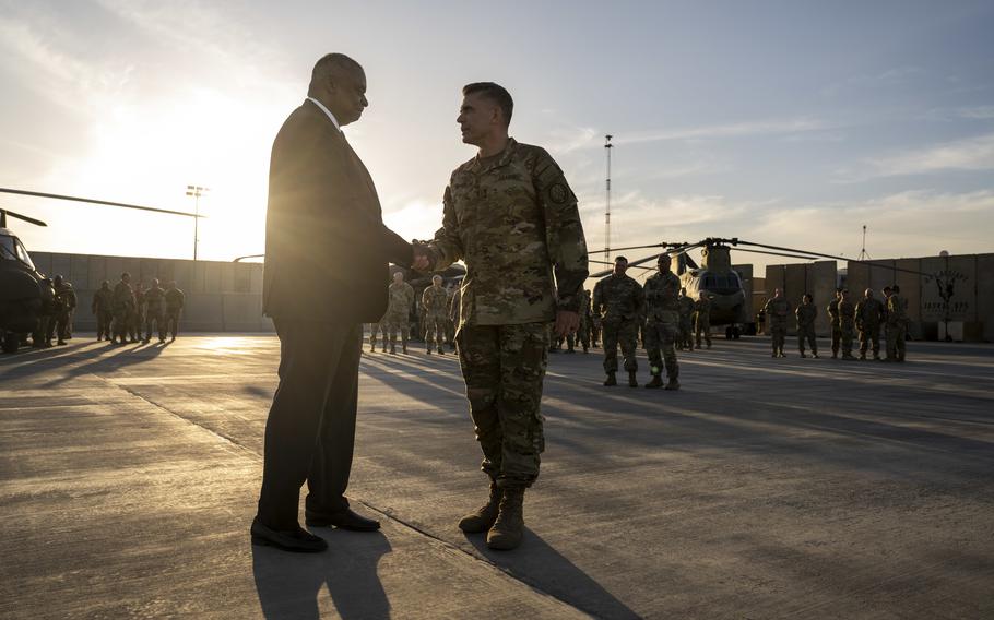 Secretary of Defense Lloyd J. Austin III speaks with Maj. Gen. Matthew W. McFarlane, while visiting Erbil, Iraq, on March 7, 2023.