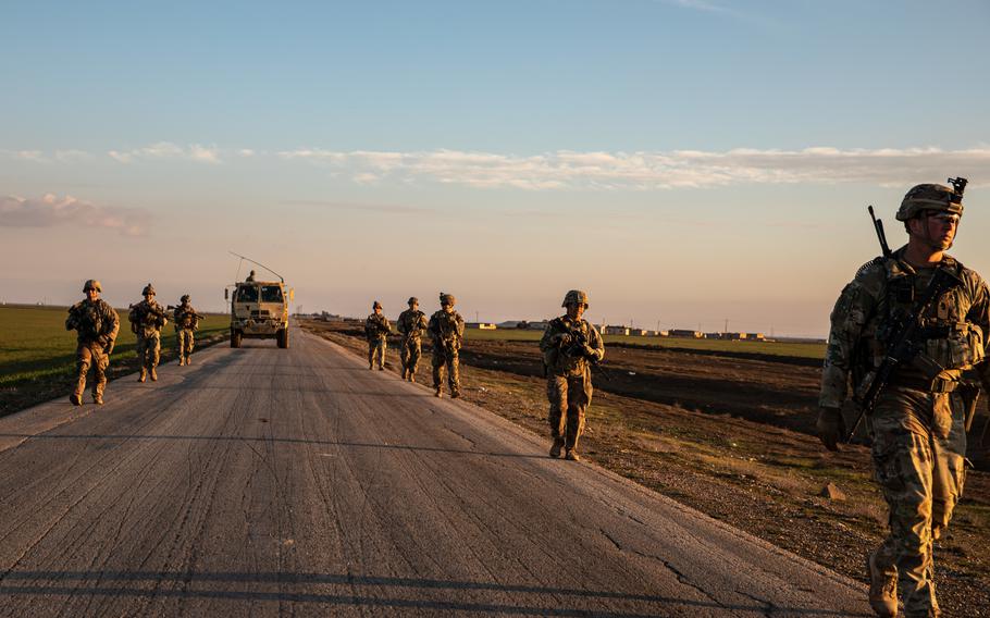 Soldiers patrol a street in Syria