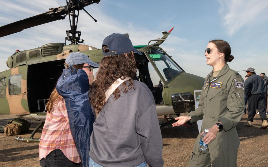 An airman answers question about her helicopter during the Beyond the Horizon Air and Space Show at Maxwell Air Force Base, Ala., Saturday, April 6, 2024. 