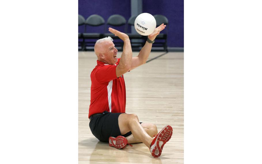 U.S. Marine Corps Sgt. Andrew Blackburn serves the ball during a demonstration of sitting volleyball at a preview event for the 2022 Department of Defense Warrior Games, at ESPN Wide World of Sports at Walt Disney World.