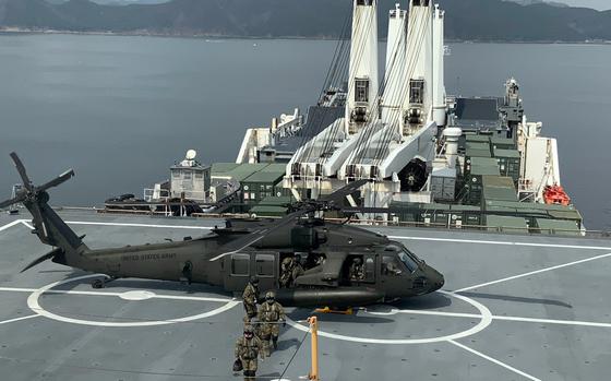 Soldiers exit a U.S. Army UH-60M Black Hawk on the deck of the USNS Dahl near South Korea's southern coast, March 7, 2024.