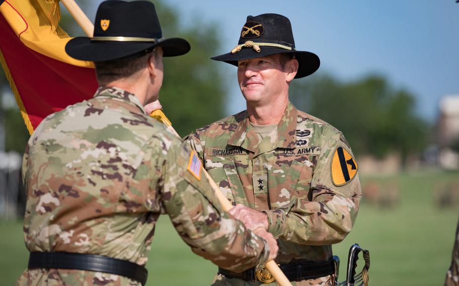 Lt. Gen. Pat White, III Corps commanding general, passes command to Maj. Gen. John B. Richardson, 1st Cavalry Division commanding general, in a ceremony July 21 here.