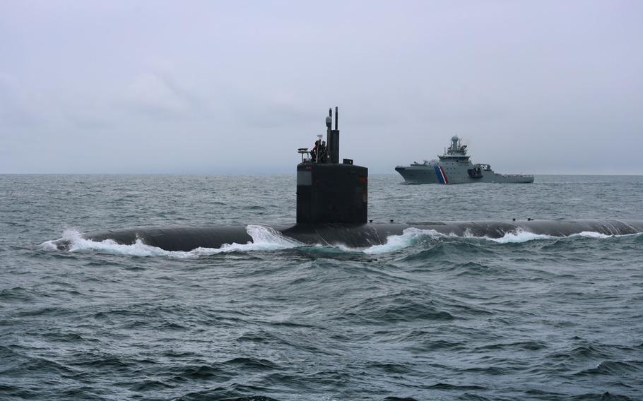 The Los Angeles-class submarine USS San Juan stops for supplies and personnel April 26, 2023, off the coast of Iceland accompanied by an Icelandic coast guard ship.