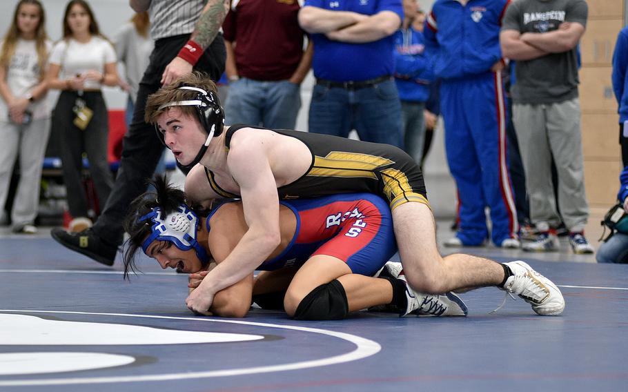 Stuttgart's Zachary Call looks up while holding Ramstein's Isaac Martinez during the 144-pound championship match at the DODEA Central sectional wrestling tournament on Saturday at Ramstein High School on Ramstein Air Base, Germany. Call won the match, 19-4.