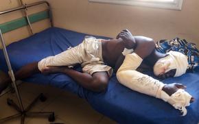 Saga Saganla, 30, from Diawely, lies on his bed at Somine Dolo hospital in Mopti, Mali, Friday June 24, 2022. Saganla survived an attack by nearly 100 jihadis on motorbikes who had gathered in his village in central Mali Sunday June 19. At least 132 people were killed in several villages in the Bankass area of central Mali during the attack on Saturday and Sunday, according to the government which blames the Group to Support Islam and Muslims jihadi rebels linked to al-Qaida.(AP Photo/ Hamidou Saye)
