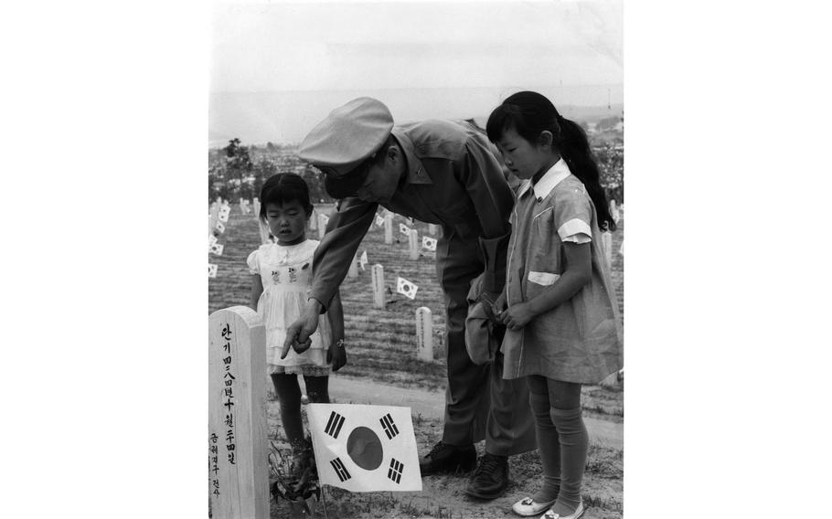 ROKA Col. Chung Yang Hong explains Memorial Day to his two daughters.