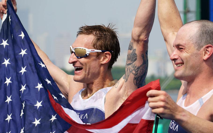 Navy veteran Bradley Snyder, left, who lost his sight during an Afghanistan blast in 2011, and Greg Billington ceberate after winning a gold medal in the Paralympic triathlon at Odaiba Marine Park, Tokyo, Saturday, Aug. 28, 2021. 