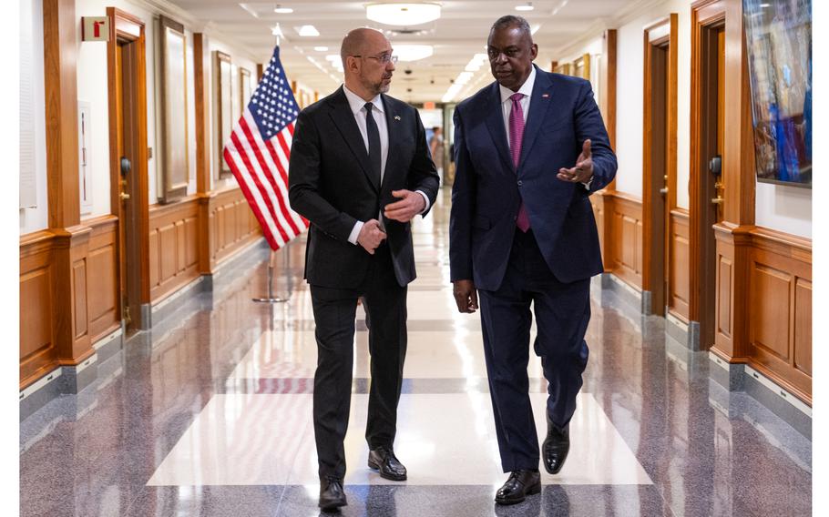 Secretary of Defense Lloyd J. Austin III, right, speaks with Ukraine Prime Minister Denys Shmyhal during a bilateral exchange meeting at the Pentagon in Arlington, Va., April 12, 2023. 