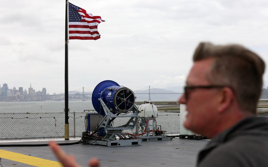 Dr. Rob Wood on the flight deck of the USS Hornet Museum with a Cloud Aerosol Research Instrument on Wednesday, April 24, 2024, in Alameda, Calif.