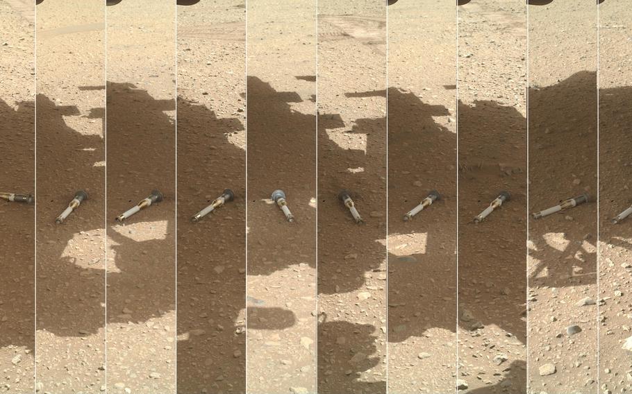 Tubes holding samples of rock cores, broken rock and dust collected by NASA’s Perseverance rover sit on the surface of Mars. The space agency’s Mars Sample Return mission aims to bring them to Earth for closer study.