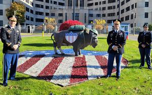 Lt. Col. Eli Adams, Maj. Lyle Milliman and 1st Lt. Stacey Acapana of the U.S. Army Corps of Engineers, Buffalo District stand in front of a buffalo statue outside the VA Western New York Medical Center in Buffalo, New York, Nov. 10, 2021. The medical center hosted current and former members of the military during the ceremony to honor veterans and recognize their service for Veterans Day 2021.