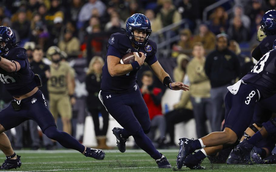 Navy quarterback Xavier Arline runs through a hole in the Army defense during the second quarter of an NCAA football game at Gillette Stadium Saturday, Dec. 9, 2023, in Foxborough, Mass. 