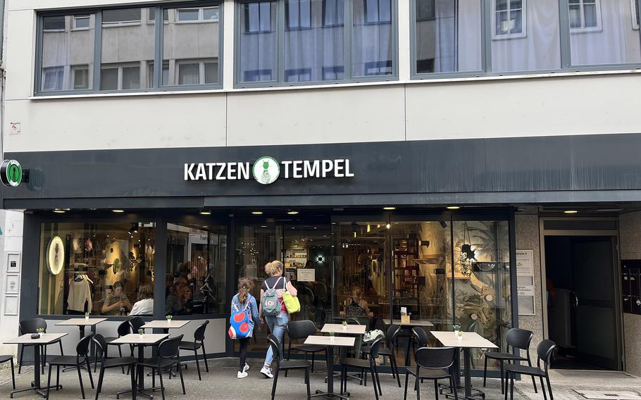 Patrons walk into Katzentempel cat cafe in Trier, Germany, on June 8, 2024.