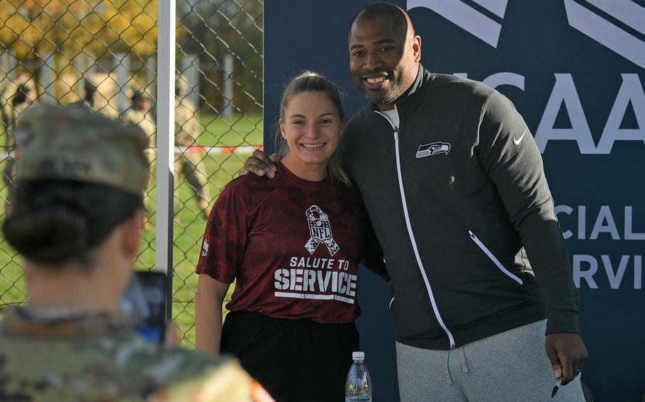Former Seattle Seahawks running back Shaun Alexander poses for photos with soldiers at the NFL Salute to Service boot camp in Vilseck, Germany, on Nov. 9, 2022. 