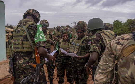 Kenya Defense Force members go over the set-up plan during a Medical Civic Action Program Event in Dolsan village, Kismayo, Somalia, July 1, 2023. More than 250 people came to seek medical aid, ranging from Dengue fever to urinary tract infections. (U.S. Air Force photo by Staff Sgt. Enrique Barcelo)