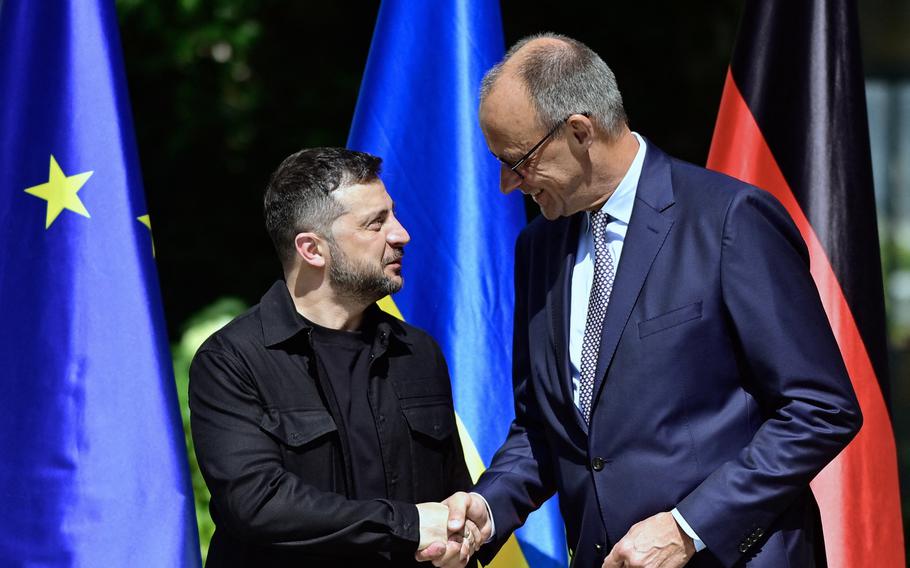 German Chancellor Friedrich Merz shakes hands with Ukrainian President Volodymyr Zelenskyy.