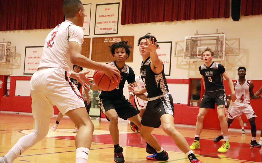 Nile C. Kinnick's Vance Lewis looks for room against Zama's Keahnu Araki and Chris Jones during Tuesday's DODEA-Japan boys basketball game. The Red Devils won 71-38.