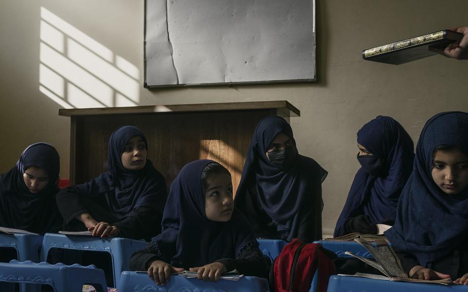 A group of students attend class at an all-female madrassa in Kabul. 
