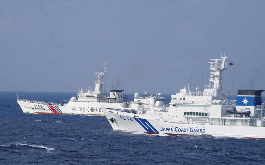 The Japan Coast Guard demands that a Chinese coast guard vessel leave Japan's territorial waters in this undated photo.