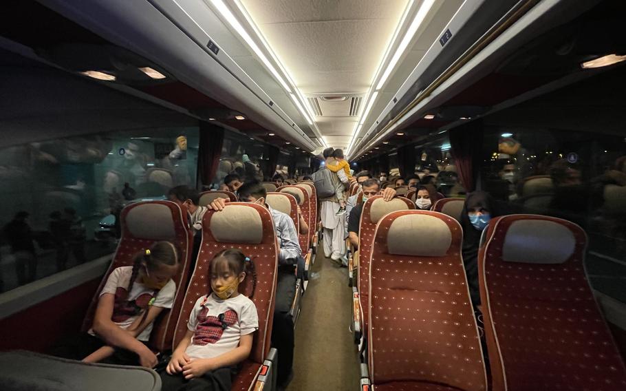 Female Afghan lawmakers along with their families ride a bus in Athens after a journey from Afghanistan, through Iran and Georgia, to Greece. 