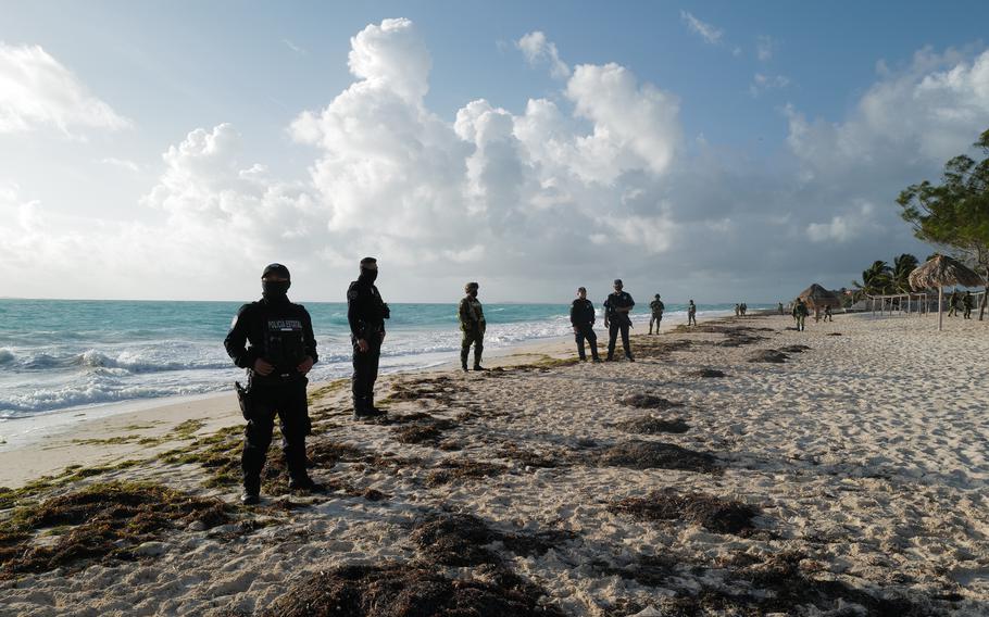 Mexican security forces oversee the destruction of an illegal establishment used by drug dealers on the outskirts of Cancún. 
