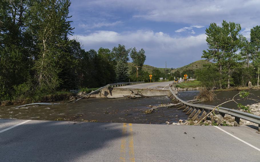A river flows through a missing section of a key bridge that leads to the tourist town of Fishtail, Mont. Friday, June 17, 2022.
