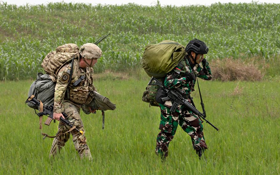 U.S. and Indonesian paratroopers march togetherduring joint airborne operations in support of the Super Garuda Shield excerise in Baturaja, Indonesia, Aug. 3, 2022.