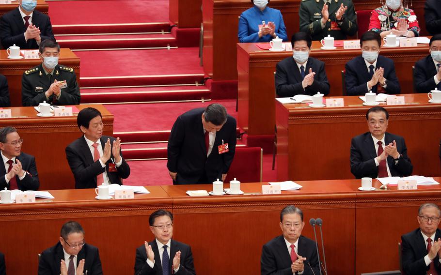 Xi Jinping, China’s president, center, bows during the closing session of the First Session of the 14th National People’s Congress (NPC) at the Great Hall of the People in Beijing, China, on Monday, March 13, 2023.