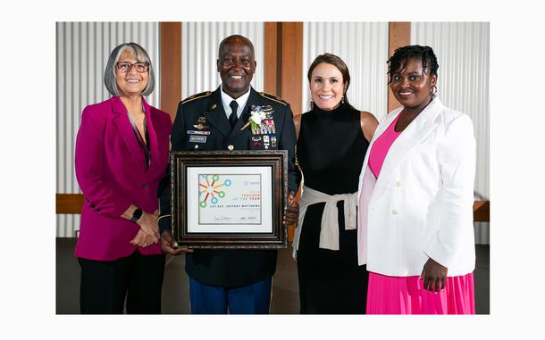 Army 1st Sgt. Jeffery Matthews of Hillside High School, holds a plaque after being selected as the Durham Public Schools Teacher of the Year.